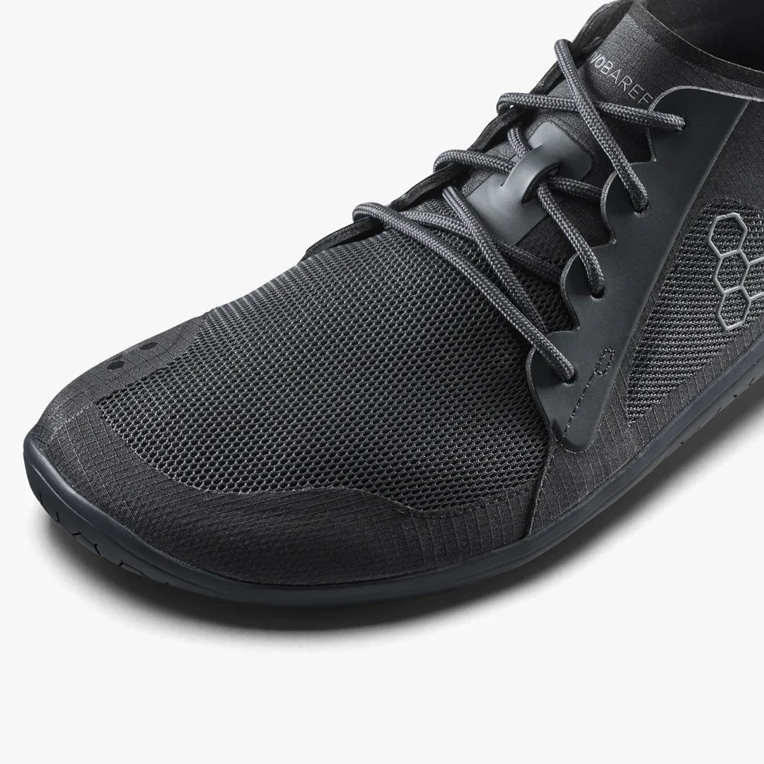 Black athletic shoe with brand logo on a white background