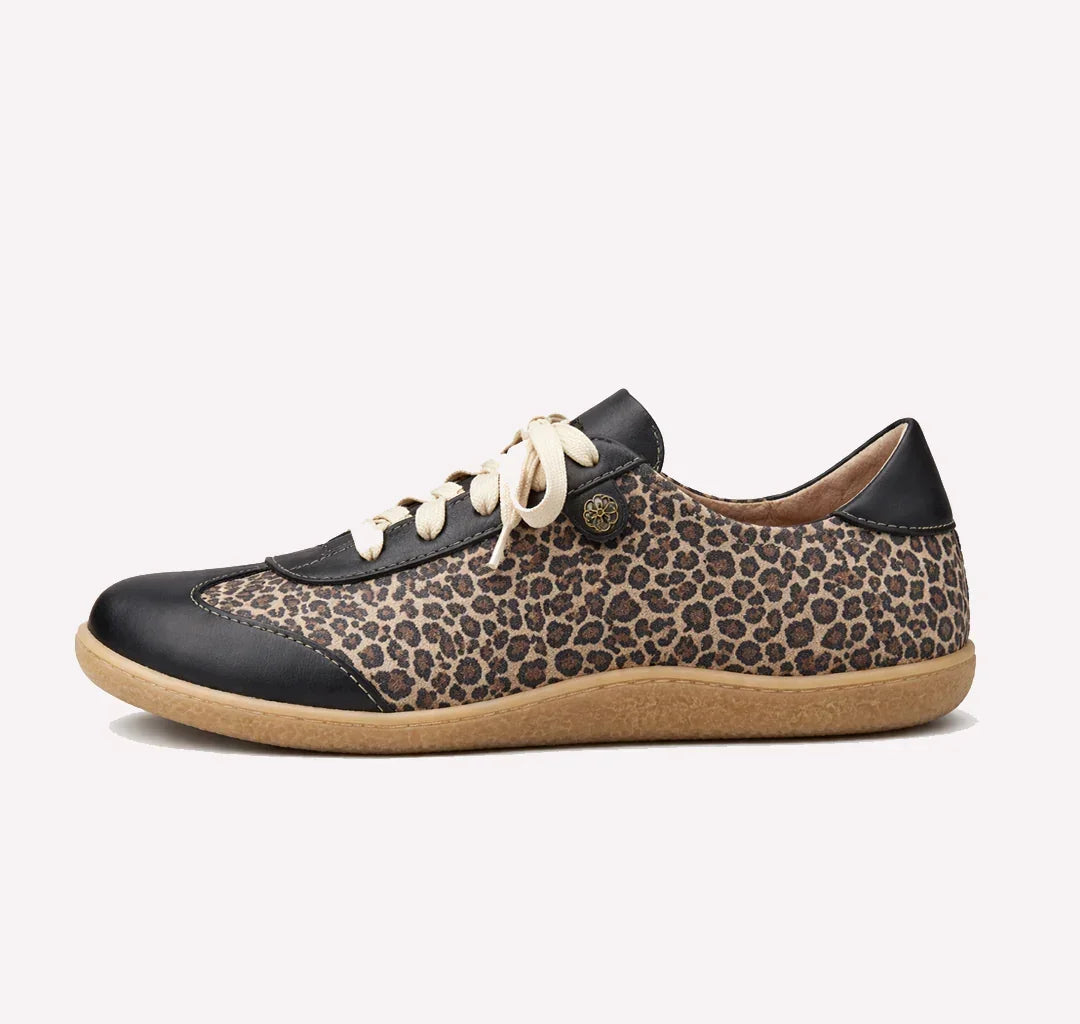 Leopard print sneaker with black and brown accents on a white background
