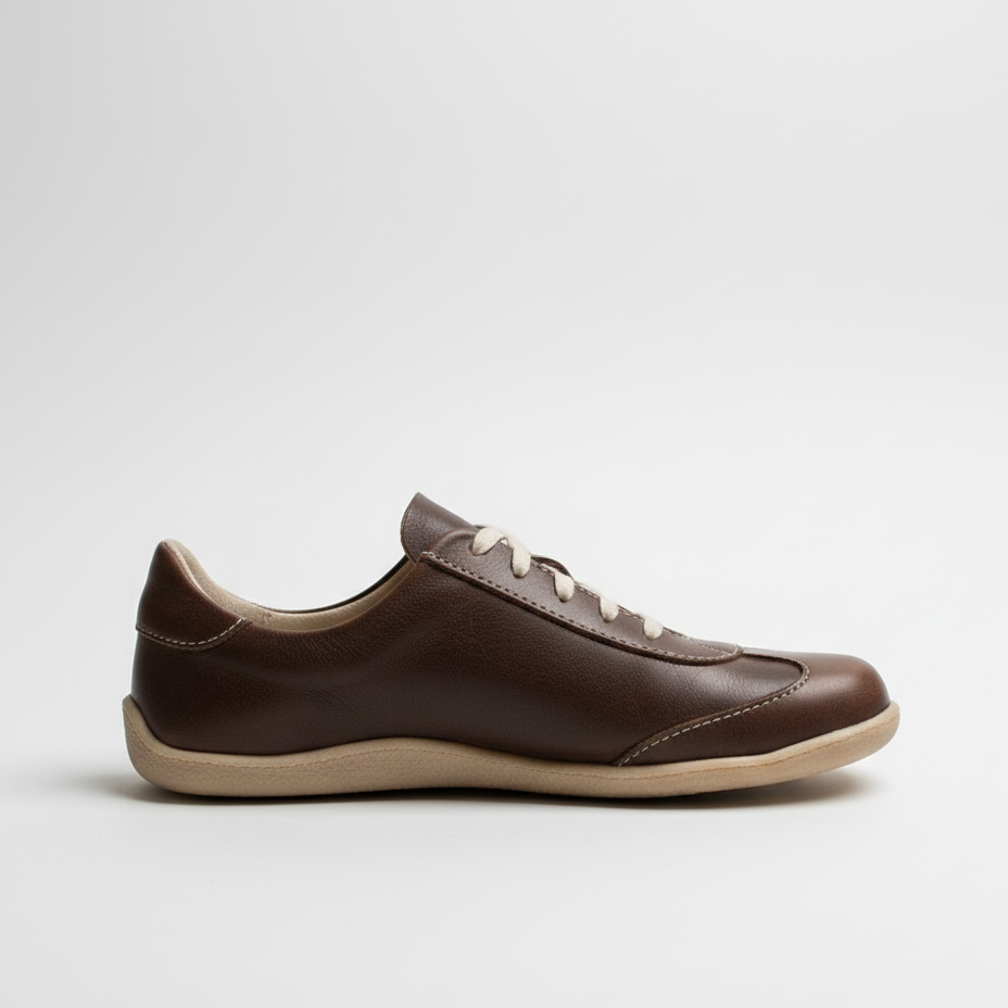 Brown leather shoe on a light gray background