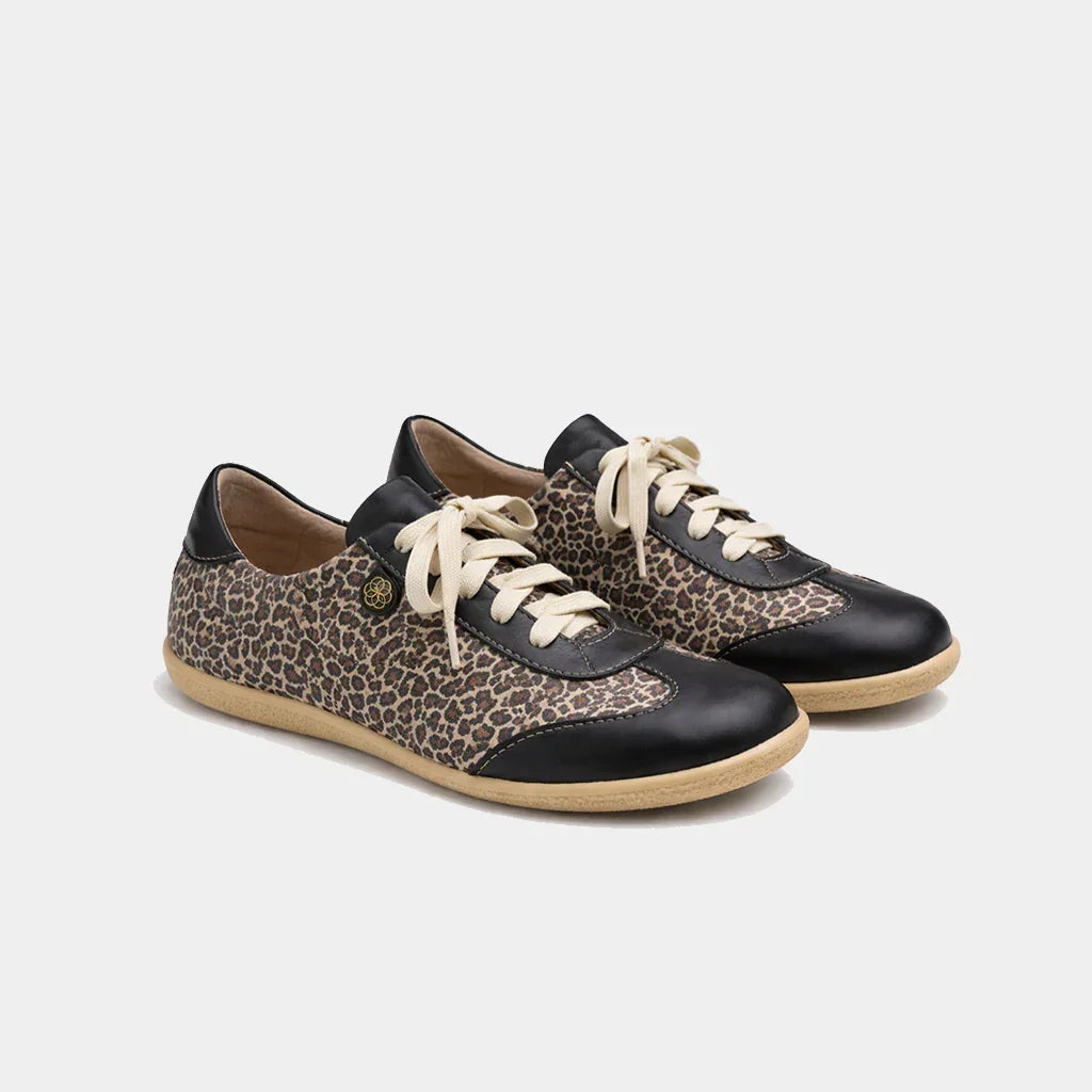 Pair of sneakers with leopard print and black accents on a light gray background