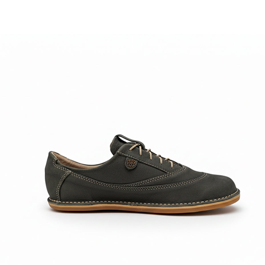 Black leather shoe with brown sole on a white background